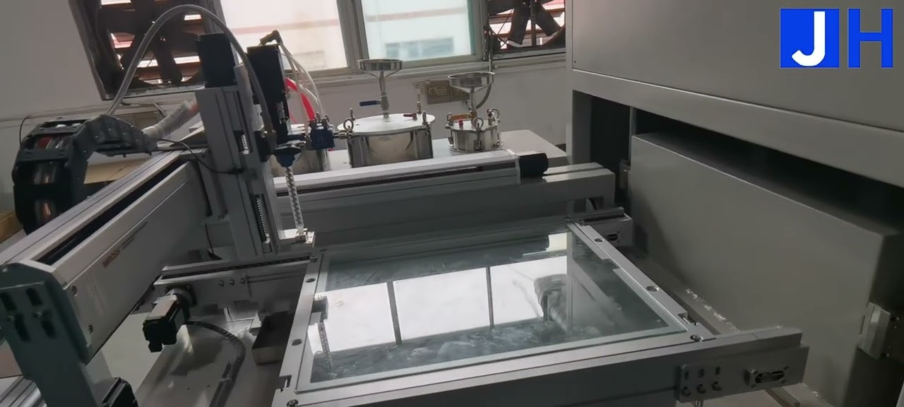 GOB dispensing machine with its gantry dispensing head and a large transparent module fixture in the foreground